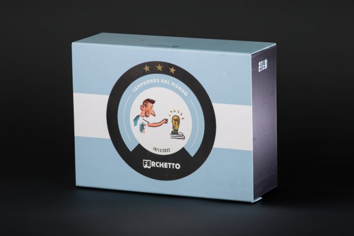 Estuche celeste de Ferchetto cerrado, con ilustración de campeones del mundo